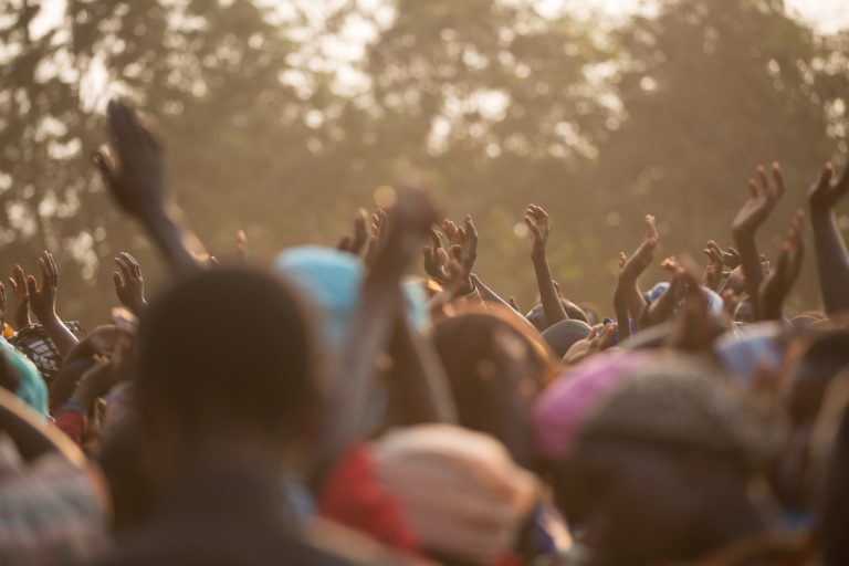 African youth on the streets celebrating the triumph of pan-African business making their communities grow